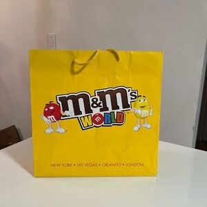 M&M'S World Yellow Gift Bag. Listed on bag
New York Las Vegas Orlando London